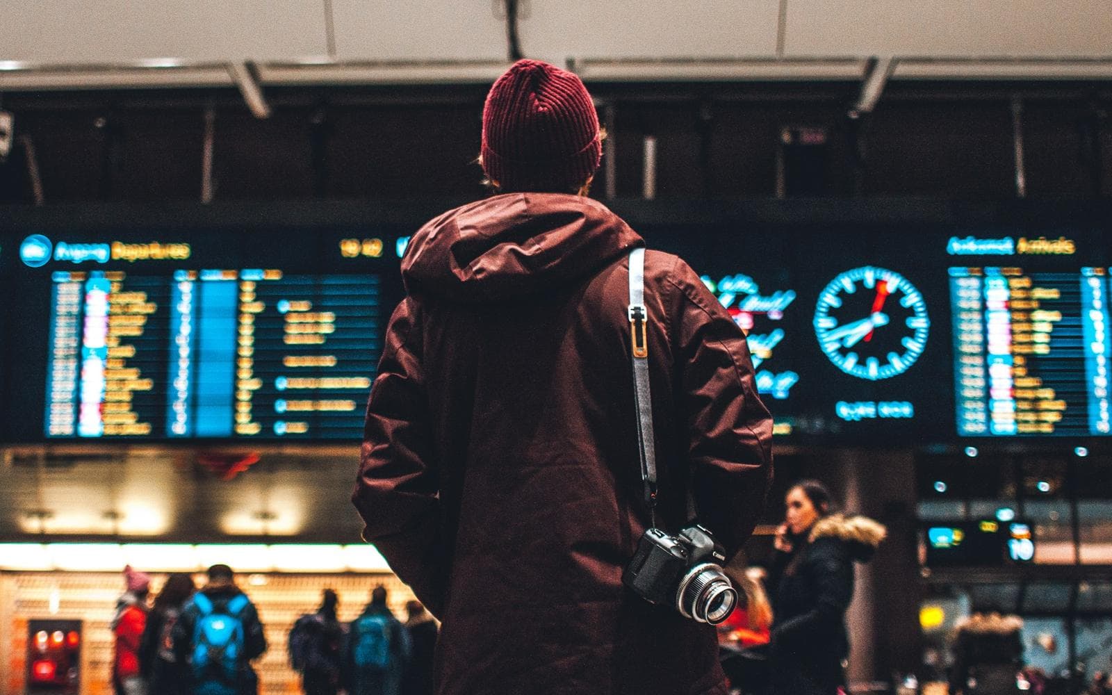 A traveller checks the departures board in an airport terminal