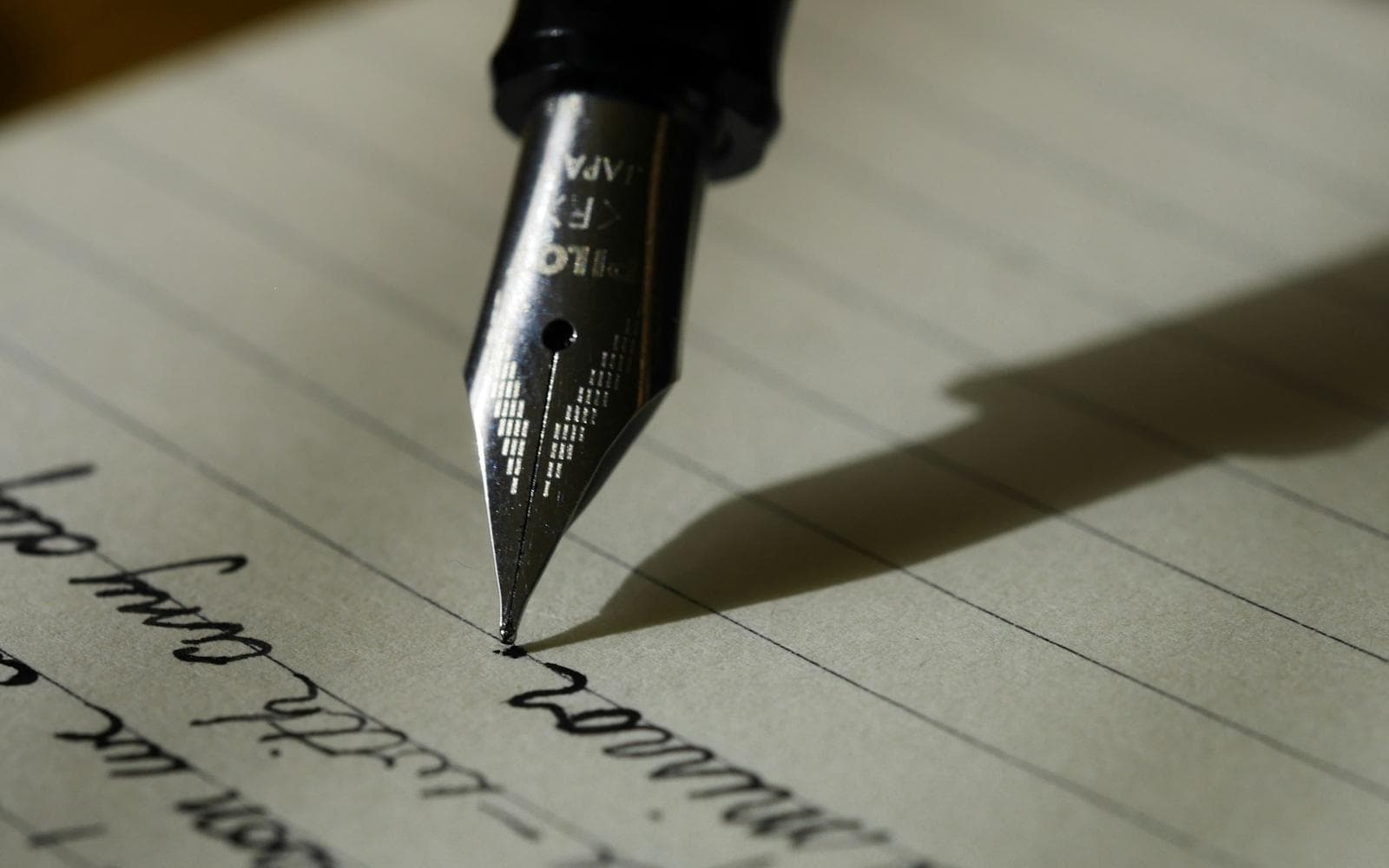 A fountain pen writing a letter